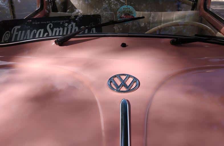 Close no símbolo da Volkswagen no Fusca rosa placa preta